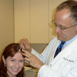 julie-1 dermatologist examines suspicious spot